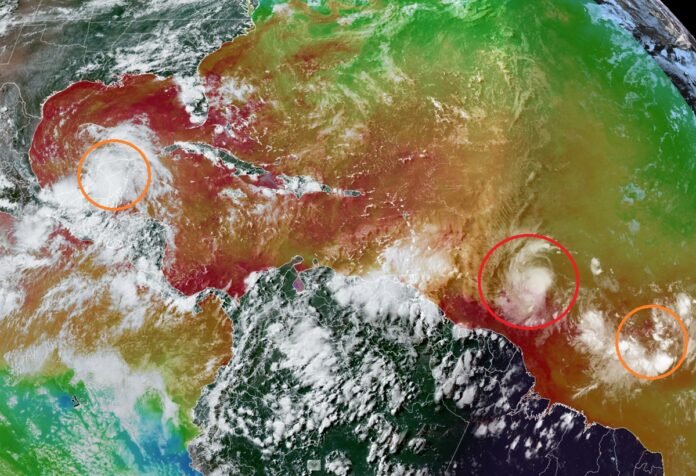 A color enhanced website shows Hurricane Beryl circled in red while two other possible tropical cyclone areas circled in orange. Image: NOAA